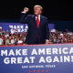 President Trump on stage during an indoor rally.