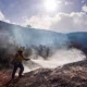 A firefighter sprays a hotspot while fighting the Bike fire