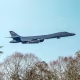 A USAF Rockwell B-1 Lancer bomber flies over the village church of St. Mary the Virgin