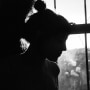 Silhouette of Young Adult Woman Sitting in Front of Window
