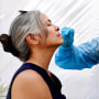 Image: A medical assistant administers a Covid-19 test to a person at Sameday Testing on July 14, 2021 in Los Angeles.