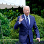 Image: President Joe Biden tries to hear questions shouted by reporters as he heads to Marine One on the South Lawn of the White House on July 16, 2021, to spend the weekend at Camp David.