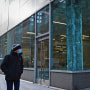 A man walks past an empty office building in the midtown area of Manhattan on Jan. 25, 2021.