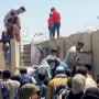 A man pulls a girl to get inside Hamid Karzai International Airport in Kabul, Afghanistan, on Aug. 16, 2021.