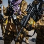 Taliban fighters armed with American weapons and equipment patrol and secure the outer perimeter alongside the American controlled side of of the Hamid Karzai International Airport in Kabul on Aug. 29, 2021.