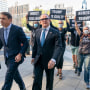 Image: Activist with Rise and Resist follow Igor Fruman, second from left, as he arrives in Federal court in Manhattan with his attorney Todd Blanche, on Sept. 10, 2021 in New York.