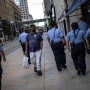 A man walks by a group of police officers in downtown Minneapolis on Sept. 8, 2021.