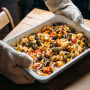 Baked vegetables with feta cheese in a baking pan