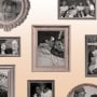 Photo illustration: Framed and family photos arranged on a beige colored surface.