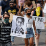 Demonstrators march over the death of Elijah McClain in Aurora, Colo., on June 27, 2020.