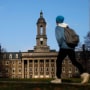 Image: A students walks in front of the Old Main building on the Penn State University campus Friday, Nov. 11, 2011, in State College, Pa.