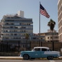 A vintage car passes by the U.S. Embassy in Havana, Cuba
