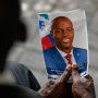 A mourner holds a photo of late Haitian President Jovenel Moise during his memorial ceremony at the National Pantheon Museum in Port-au-Prince on July 20, 2021.