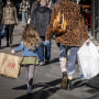 Pedestrians carry shopping bags on Powell Street in San Francisco on Dec. 30, 2021.