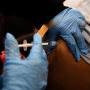 A health worker administers a Covid-19 vaccination in Philadelphia on Dec. 20, 2021.