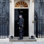 Police stand outside 10 Downing Street, in London
