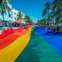 People carry a rainbow flag during the Miami Beach Pride Festival in South Beach, Fla., on Sept. 19, 2021.