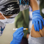 Image: A healthcare worker administers a dose of the Moderna Covid-19 vaccine in Gilroy, Calif., on March 4, 2021.