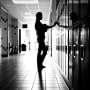 A student stands in a school hallway