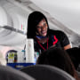An American Airlines flight attendant serves drinks to passengers after departing from Dallas/Fort Worth International Airport in Texas on Oct. 3, 2017.