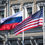 A Russian national flag, left, and an American national flag fly outside the Presidential Palace in Helsinki, Finland on July 16, 2018.