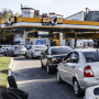 Drivers line up in long queues at a gas station amid the fuel supply cutoff in Kyiv on May 11, 2022.