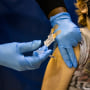 A health care worker administers a dose of the Pfizer-BioNTech Covid-19 vaccine to a child at a Salvation Army vaccination clinic in Philadelphia on Nov. 12, 2021.