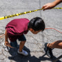 Image: A child crosses under police tape at the Robb Elementary School in Ulvade, Texas, on Wednesday. Nineteen students and two teachers were killed by a shooter on Tuesday.