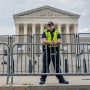 A U.S Supreme Court Police officer stands guard outside the Supreme Court on June 13, 2022.