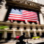 Image: A person bikes past the New York Stock Exchange on June 29, 2022 in New York.