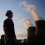 Image: A worker stands in a coal yard in Winfield, W.V., on July 18, 2018.