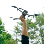 A man holds a drone with his hand