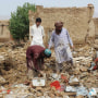 Image: Residents clear debris after the roof of a house collapsed due to a heavy monsoon rainfall on the outskirts of Quetta, Pakistan, on July 5, 2022.