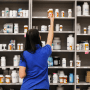 A pharmacy technician grabs a bottle of drugs off a shelf on Sept. 10, 2018, in Midvale, Utah.