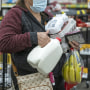 A shopper holds groceries while waiting to checkout inside a grocery store in San Francisco, California, U.S., on Monday, May 2, 2022. U.S. inflation-adjusted consumer spending rose in March despite intense price pressures, indicating households still have solid appetites and wherewithal for shopping.