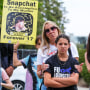 People opposed to the sale of illegal drugs on Snapchat participate in a rally