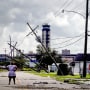 A woman looks over damage to a neighborhood caused by Hurricane Ida on Aug. 30, 2021 in Kenner, La.