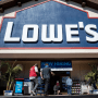 People walk towards the entrance of a Lowe's store