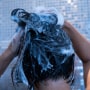 Close-up of woman washing her hair in bathroom