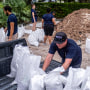 A volunteer loads sand bags into pick up truck for a customer in preparation for the arrival of Hurricane Ian in Tampa, Fla., on Sept. 27, 2022.