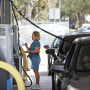 After waiting in lengthy lines, customers fill their vehicles with gas ahead of the oncoming storm in Kissimmee, Fla., on Sept. 26, 2022.