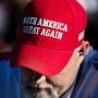 A person wears a MAGA hat