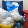 Trash containers overflow with garbage at Health Park Medical Center in Fort Myers, Fla.