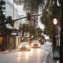 Cars drive through a nearly-deserted Charleston historic district