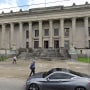Pedestrians walk past Orleans Parish District Court, in New Orleans.