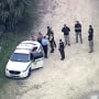 Law enforcement officers investigate the death of a U.S. Customs and Border Protection officer after he was shot at a gun range in southwest Miami-Dade, on Wednesday.