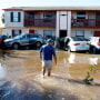 A man walks through flood waters to his apartment in Fort Myers