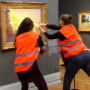 Climate activists throw mashed potatoes on a Monet painting at the Barberini Museum in Potsdam, Germany, on Oct. 23, 2022.