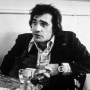 Martin Scorsese sits in a cafe on Mulberry Street in Little Italy, during the making of his film, 'Mean Streets,' New York City, October 1973