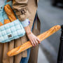 German model Alexandra Lapp holds a baguette during Paris Fashion Week on Feb. 25, 2020.